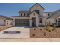 Two-story home with gray garage door and landscaped yard at 35775 N Zinc Dr, San Tan Valley, AZ 85144