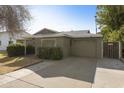 House exterior featuring a grey garage door and a landscaped front yard at 4305 E Earll Dr, Phoenix, AZ 85018