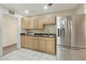 Bright kitchen with stainless steel appliances and light wood cabinets at 4305 E Earll Dr, Phoenix, AZ 85018