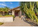 Home's front entrance with a red door and circular pathway at 4532 E Sandra Ter, Phoenix, AZ 85032