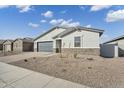 Beautiful single-story home with gray paint and paver driveway at 5030 W Hunter Trl, San Tan Valley, AZ 85144