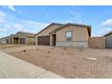 Front view of a tan house with a two-car garage at 5030 W Hunter Trl, San Tan Valley, AZ 85144