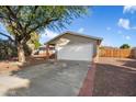 House exterior showcasing a white garage door and a tree-lined driveway at 527 N Valencia Pl, Chandler, AZ 85226