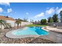 Inviting kidney-shaped pool with surrounding rock landscaping at 527 N Valencia Pl, Chandler, AZ 85226