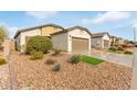 Light beige house with brown garage door, landscaping, and artificial turf at 5590 W Victory Way, Florence, AZ 85132