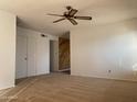 Spacious living area with ceiling fan and wall-to-wall carpet at 702 W Grove Cir, Mesa, AZ 85210