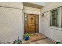 Elegant wood front door with decorative accents at 7313 E Pleasant E Run, Scottsdale, AZ 85258