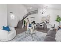 Bright and spacious living room with high ceilings, hardwood floors, and a modern aesthetic at 9144 E Pershing Ave, Scottsdale, AZ 85260