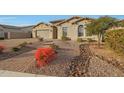 House exterior with a paved pathway, drought-resistant landscaping, and a two-car garage at 9184 W Donald Dr, Peoria, AZ 85383