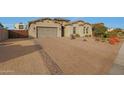 Front view of a house with a large driveway and drought-tolerant landscaping at 9184 W Donald Dr, Peoria, AZ 85383