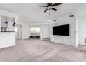 Spacious living room featuring carpeting and a large TV at 11680 E Sahuaro Dr # 2030, Scottsdale, AZ 85259