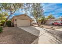 House exterior showcasing a two-car garage and driveway at 11921 W Port Royale Ln, El Mirage, AZ 85335