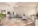 Spacious living room with neutral decor and tile floors at 11921 W Port Royale Ln, El Mirage, AZ 85335