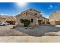 Two-story house with tan exterior, a three-car garage, and a landscaped front yard at 13305 W Indianola Ave, Litchfield Park, AZ 85340