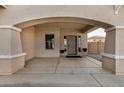 Covered front porch with a double door entry and arched entryway at 13305 W Indianola Ave, Litchfield Park, AZ 85340