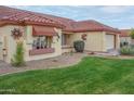 Well-maintained house with desert landscaping and a Spanish-style design at 14131 W Circle Ridge Dr, Sun City West, AZ 85375