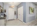 Light and bright entryway with coat closet and wood-look floors at 16036 W Sandia Park Dr, Surprise, AZ 85374