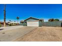 Newly painted home with a spacious driveway and desert landscaping at 1653 N 69Th Ave, Phoenix, AZ 85035