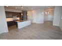 Open-concept kitchen with dark wood cabinets, granite countertops, and stainless steel appliances at 19315 W Luke Ave, Litchfield Park, AZ 85340