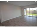 Bright living room with tile flooring and sliding glass doors leading to the backyard at 19315 W Luke Ave, Litchfield Park, AZ 85340