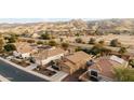 Aerial view of houses with solar panels and mountain backdrop at 2023 E Fawn Dr, Phoenix, AZ 85042