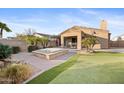 Home exterior with hot tub and putting green at 2023 E Fawn Dr, Phoenix, AZ 85042