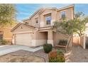 Tan two-story home featuring a two-car garage, manicured landscaping, and a front entryway at 2159 S Luther --, Mesa, AZ 85209