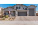 Two-story home with gray exterior, three-car garage, and landscaped front yard at 25509 N 140Th Dr, Surprise, AZ 85387