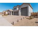 Two-story home with gray exterior, three-car garage, and landscaped front yard at 25509 N 140Th Dr, Surprise, AZ 85387