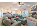 Spacious living room featuring a comfortable sectional sofa and fireplace at 26063 N 83Rd Dr, Peoria, AZ 85383