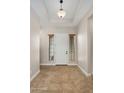 Bright entryway with tile flooring and neutral color palette at 30401 N 115Th Dr, Peoria, AZ 85383