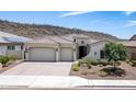 Single-story home with two-car garage and desert landscaping at 30401 N 115Th Dr, Peoria, AZ 85383