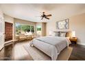 Serene bedroom with abundant natural light and a relaxing sitting area by the windows at 30626 N 45Th Pl, Cave Creek, AZ 85331