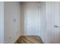 Modern apartment entryway with white door and wood-look floors at 3131 N Central Ave # 6015, Phoenix, AZ 85012