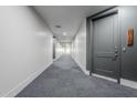 Modern apartment hallway with gray carpet and doors at 3131 N Central Ave # 6015, Phoenix, AZ 85012