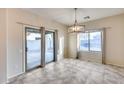 Bright dining room with sliding glass door to backyard at 3167 E Battala Ct, Gilbert, AZ 85297