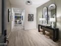 Bright entryway featuring wood-look tile flooring, stylish console table, mirrors and decor at 3332 W Sunstone Dr, San Tan Valley, AZ 85144