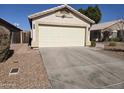 Spacious two-car garage with a concrete driveway and low-maintenance desert landscaping at 3560 W Tina Ln, Glendale, AZ 85310