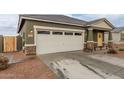 Modern house with a two-car garage and stone accents at 36060 W Santa Clara Ave, Maricopa, AZ 85138