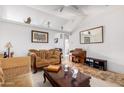 Living room with two sofas, coffee table, and built-in shelving at 4202 S 76Th Ln, Phoenix, AZ 85043