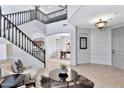 Bright and airy entryway with elegant staircase and views to the living and dining areas at 4364 E Turnberry Ct, Gilbert, AZ 85298