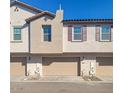 Tan two-story townhome with attached garage and purple shutters at 4641 S Glacier St, Mesa, AZ 85212