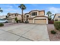 Two story house with a three car garage and a long driveway at 517 N Cambridge St, Gilbert, AZ 85233