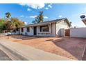 House with a front yard, walkway and white picket fence at 5321 W Country Gables Dr, Glendale, AZ 85306