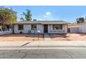 Charming ranch home with a well-maintained front yard and sidewalk at 5321 W Country Gables Dr, Glendale, AZ 85306