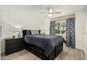 Bright bedroom with a queen-size bed, dresser, and ceiling fan at 5518 E Lindstrom Ln # A12, Mesa, AZ 85215