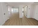 Bright hallway with light wood flooring, leading to other rooms at 634 E Calavar Rd, Phoenix, AZ 85022