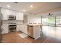 Modern kitchen with white shaker cabinets, stainless steel appliances, and hardwood floors at 7137 E Rancho Vista Dr # 6010, Scottsdale, AZ 85251