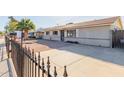 Front view of a single-story home with a rock garden and a metal fence at 7501 E Pierce St, Scottsdale, AZ 85257