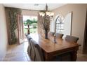 Formal dining room features a large wooden table and access to backyard at 7701 S Butte Ave, Tempe, AZ 85284